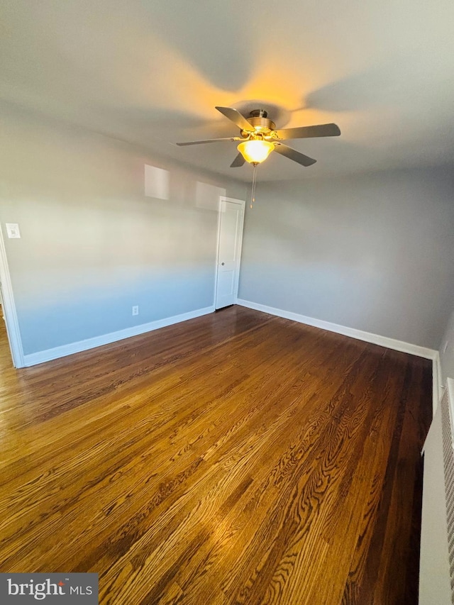 spare room featuring ceiling fan and dark hardwood / wood-style flooring