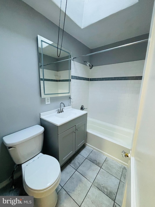 full bathroom featuring tile patterned floors, vanity, toilet, and tiled shower / bath combo