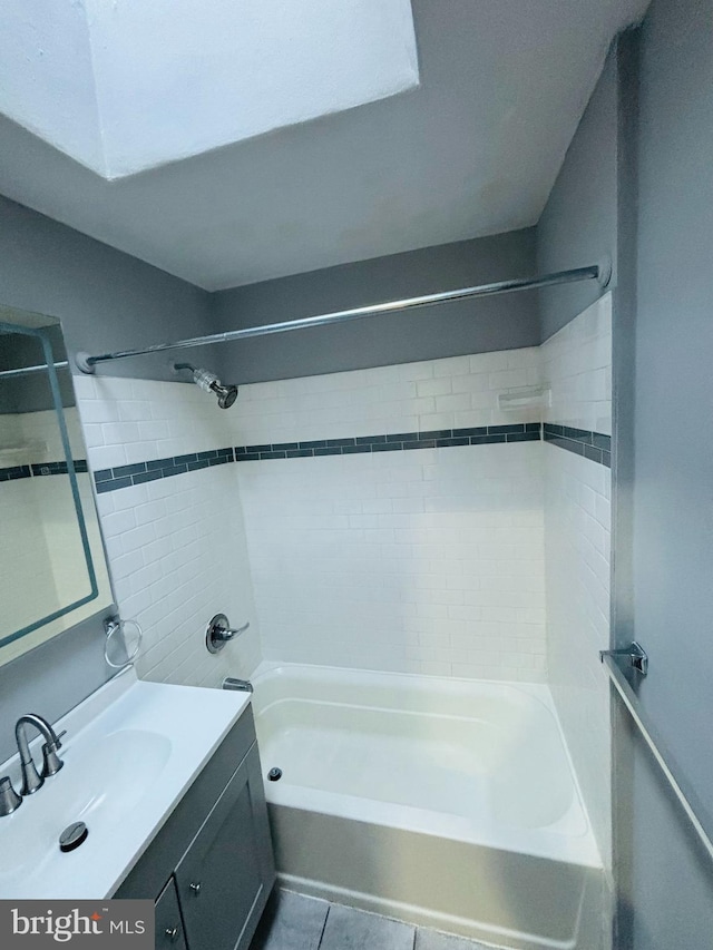 bathroom featuring tile patterned floors, vanity, and tiled shower / bath