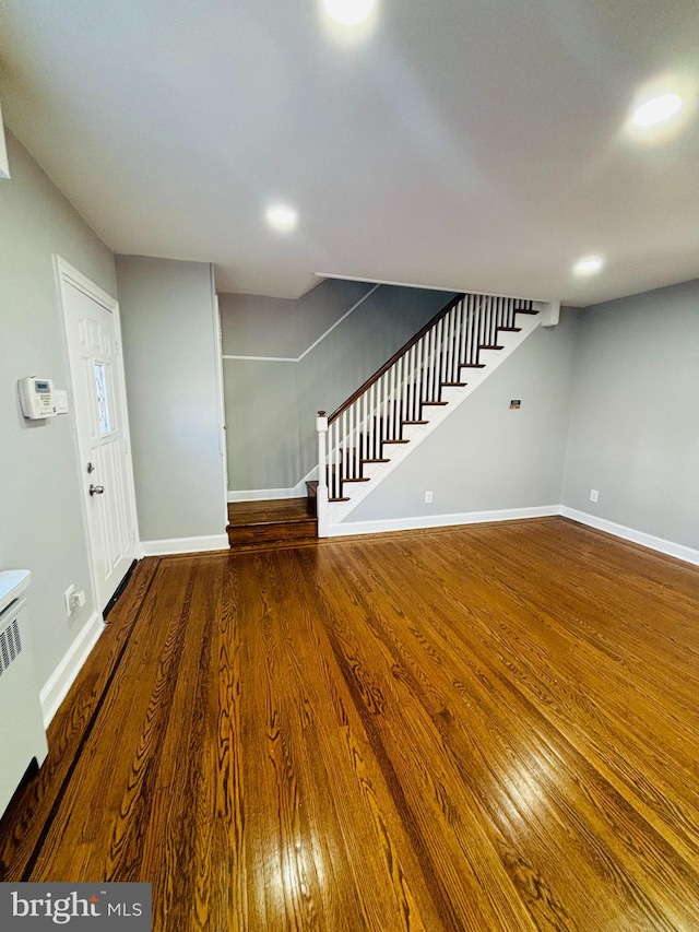 interior space featuring radiator heating unit and hardwood / wood-style flooring