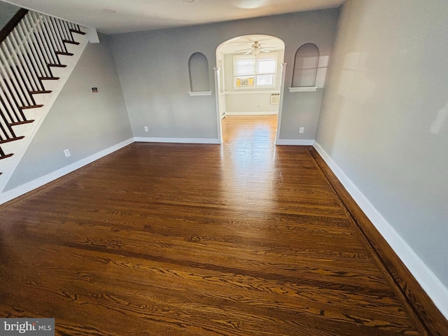 spare room with ceiling fan and dark hardwood / wood-style flooring