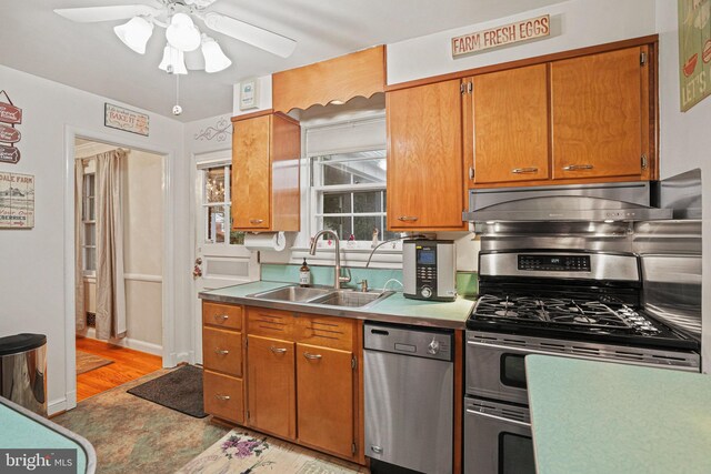 kitchen featuring ceiling fan, light wood-type flooring, sink, and appliances with stainless steel finishes