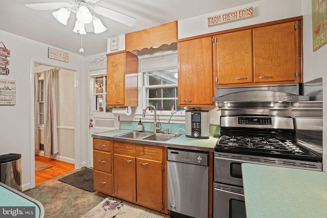 10501 Glenhaven Dr, Silver Spring, MD 20902 - kitchen with stainless steel appliances, a ceiling fan, light wood-type flooring, and brown cabinets
