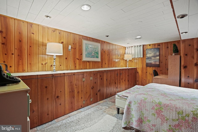 bedroom featuring wood walls