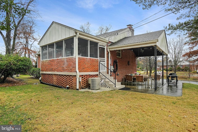 10501 Glenhaven Dr, Silver Spring, MD 20902 - rear view of property with brick siding, a sunroom, a patio area, a yard, and a chimney