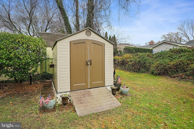 view of outdoor structure featuring a lawn