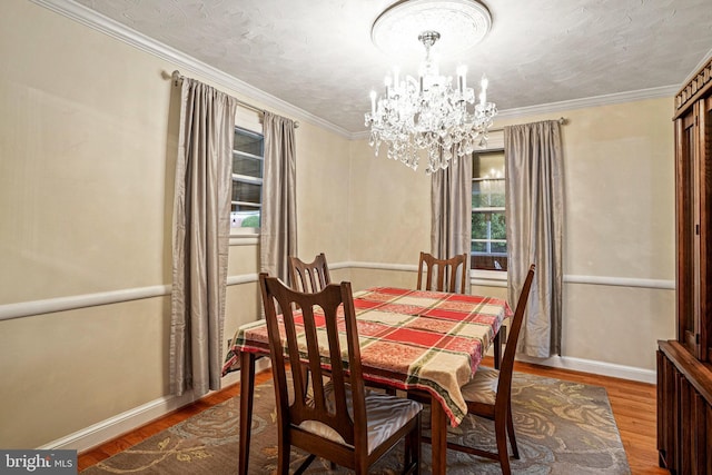 dining space featuring a chandelier, hardwood / wood-style floors, and ornamental molding