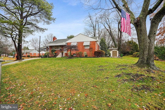 view of front facade featuring a storage unit, covered porch, and a front lawn