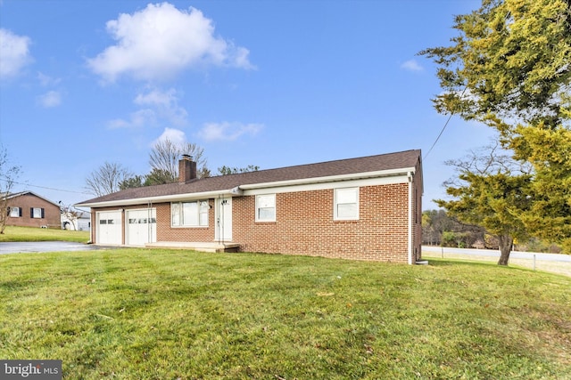 view of front of house with a front yard and a garage