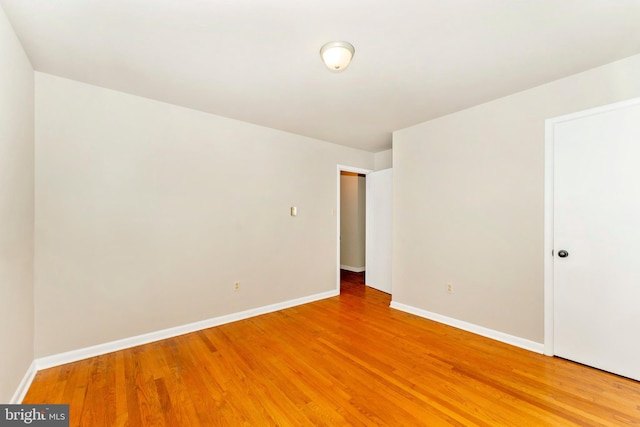 spare room featuring wood-type flooring