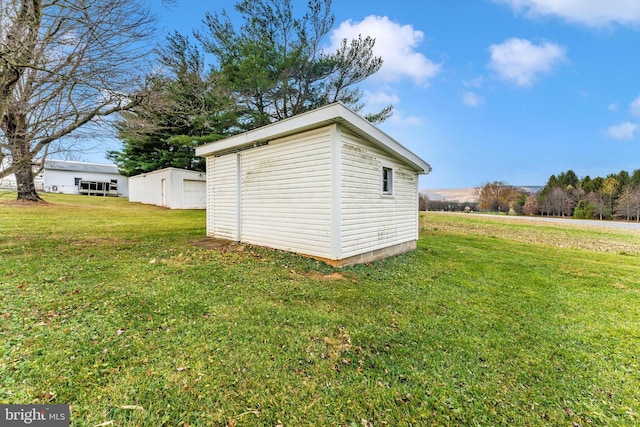 view of outbuilding featuring a yard