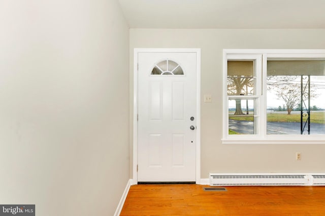 foyer entrance featuring light hardwood / wood-style floors and baseboard heating