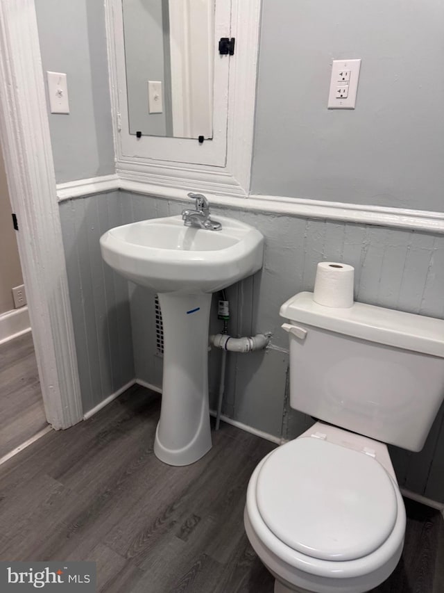 bathroom featuring sink, toilet, and hardwood / wood-style flooring