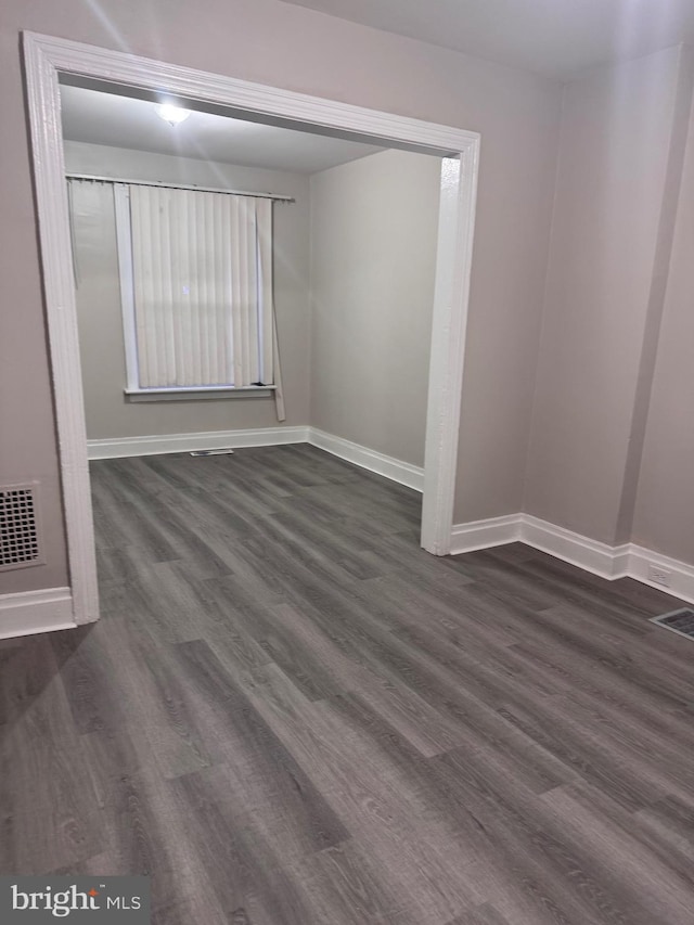 empty room featuring dark wood-type flooring