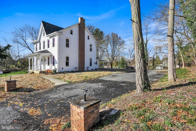 view of side of property featuring a porch