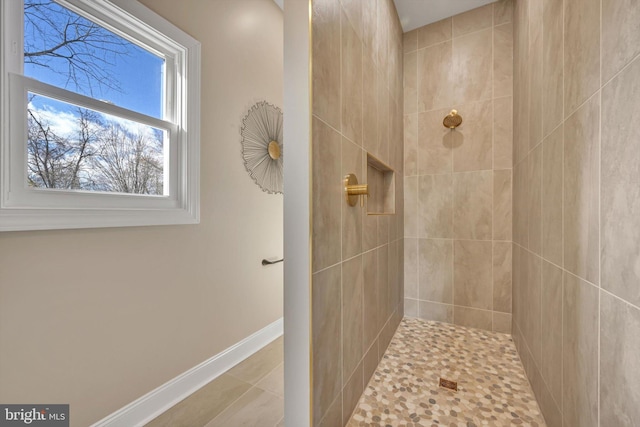 bathroom featuring a tile shower