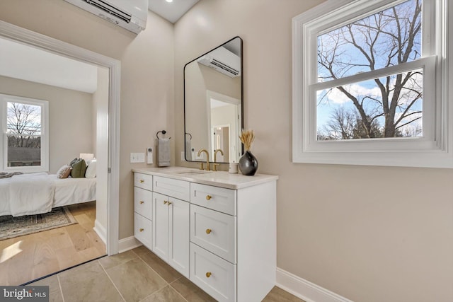 bathroom featuring hardwood / wood-style flooring, vanity, and an AC wall unit