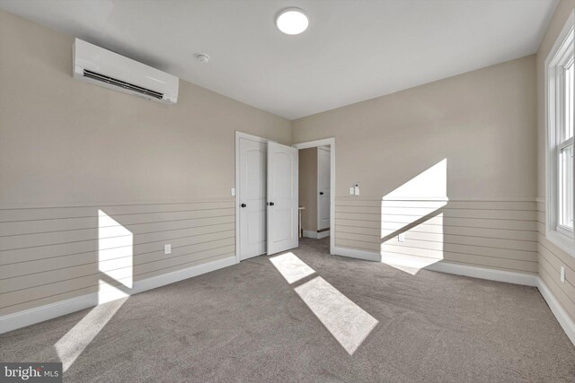 carpeted empty room with a wall mounted AC