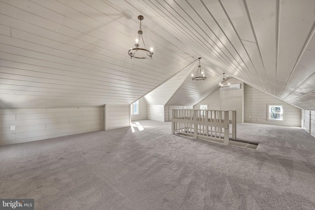 additional living space featuring carpet flooring, wooden ceiling, a wall unit AC, wood walls, and lofted ceiling