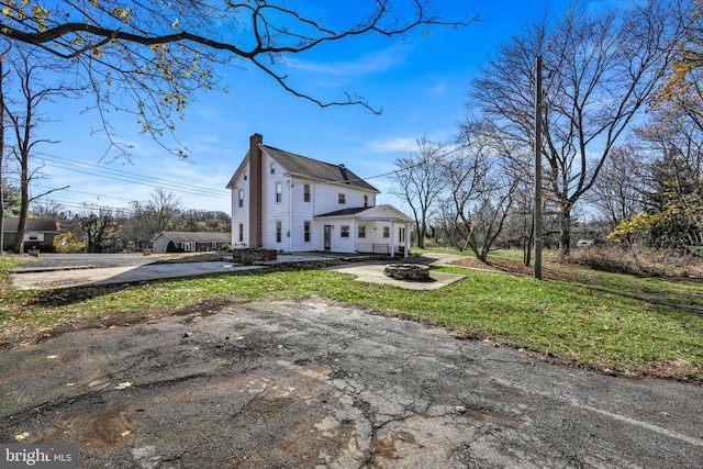 view of property exterior featuring a lawn and a carport