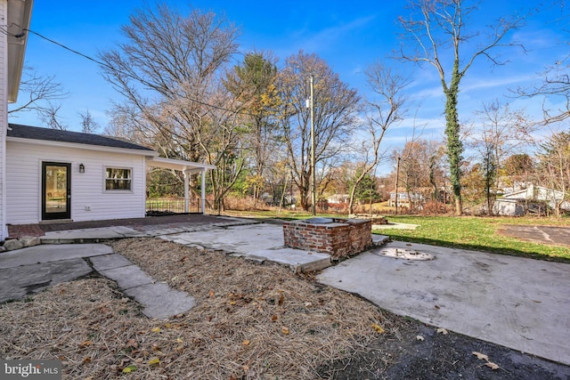 view of yard featuring a patio and a fire pit