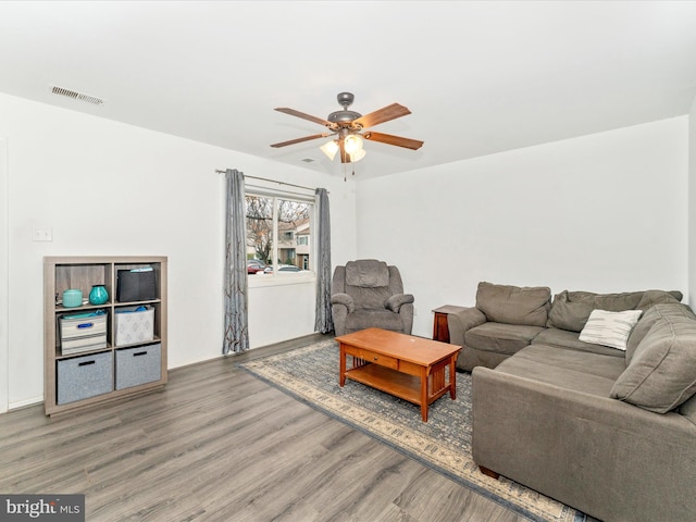 living room featuring hardwood / wood-style flooring and ceiling fan