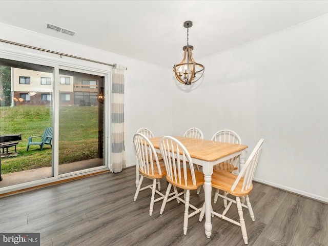 dining space with a chandelier and dark hardwood / wood-style floors