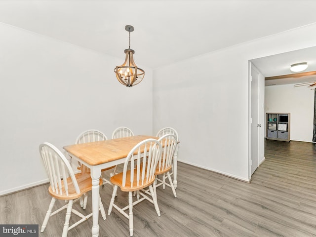 dining room with hardwood / wood-style flooring and an inviting chandelier