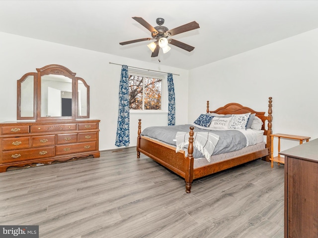 bedroom with light hardwood / wood-style floors and ceiling fan