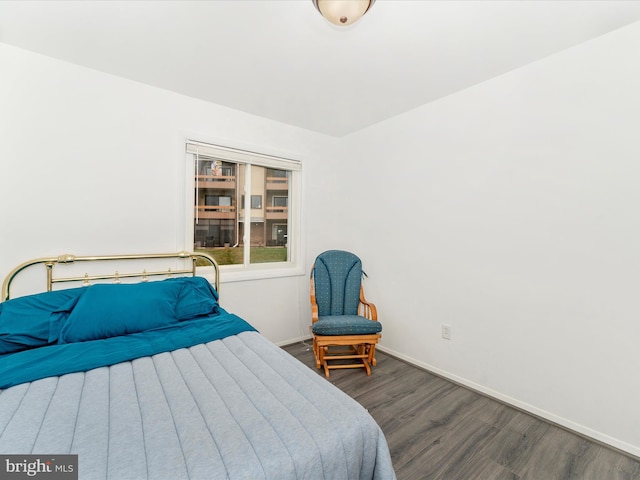 bedroom with dark wood-type flooring