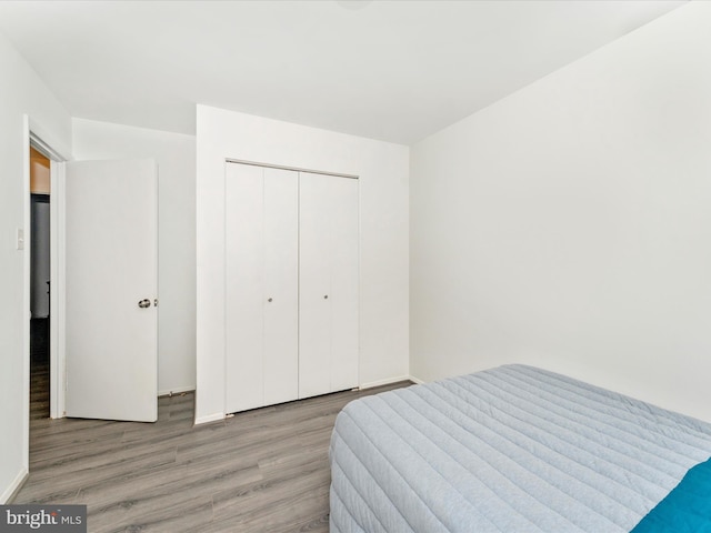 bedroom featuring a closet and light hardwood / wood-style flooring