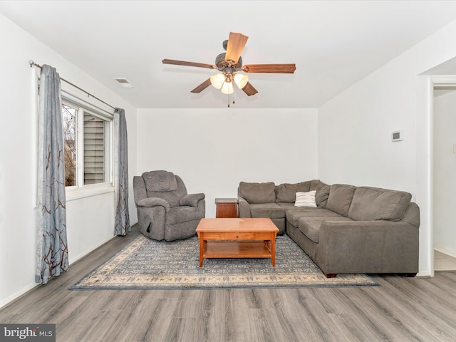 living room featuring hardwood / wood-style floors and ceiling fan