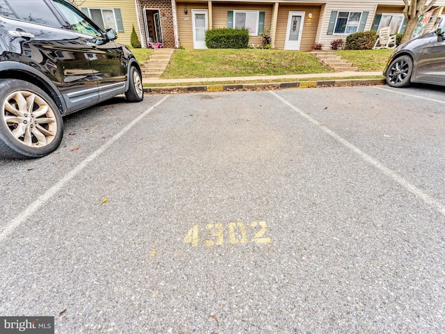 view of parking featuring a yard