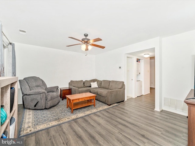 living room featuring ceiling fan and wood-type flooring