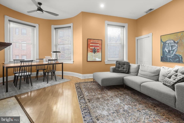 living room with hardwood / wood-style floors and ceiling fan