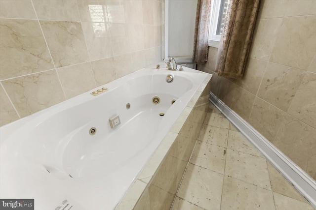 bathroom featuring a relaxing tiled tub, tile patterned floors, and tile walls