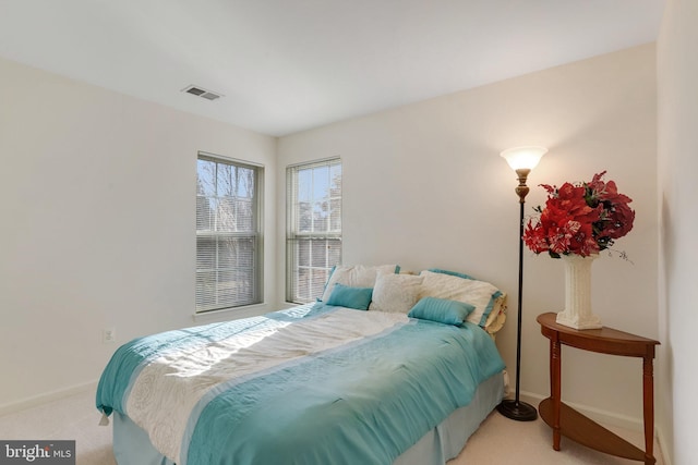 bedroom featuring light carpet, baseboards, and visible vents