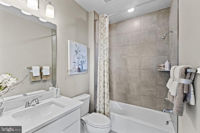 full bathroom with shower / bath combination with curtain, vanity, and toilet