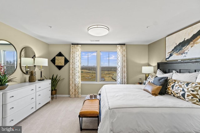 bedroom featuring multiple windows and light carpet