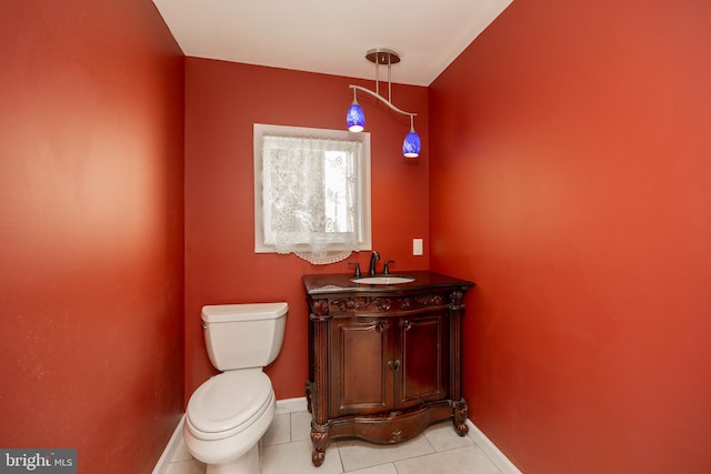 bathroom featuring toilet, vanity, and tile patterned floors