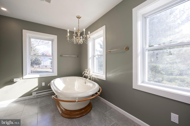 bathroom featuring a chandelier, tile patterned flooring, a tub to relax in, and baseboard heating