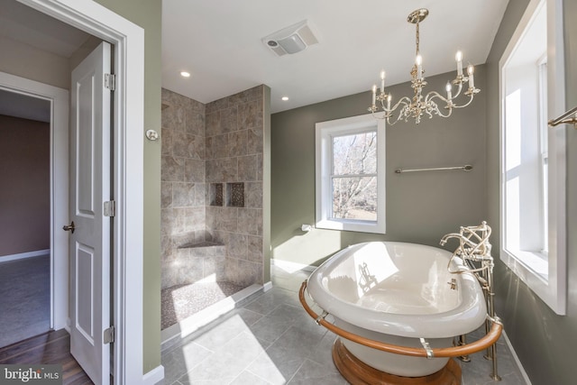 bathroom featuring tile patterned flooring, a chandelier, and plus walk in shower