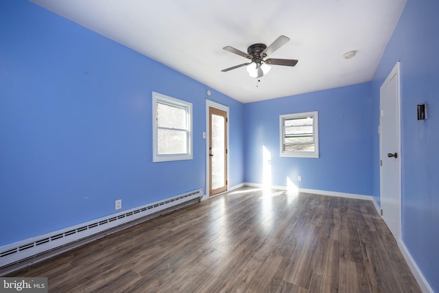 spare room featuring baseboard heating, ceiling fan, and wood-type flooring