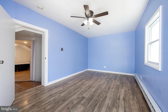 unfurnished room with vaulted ceiling, ceiling fan, a baseboard radiator, and dark hardwood / wood-style floors