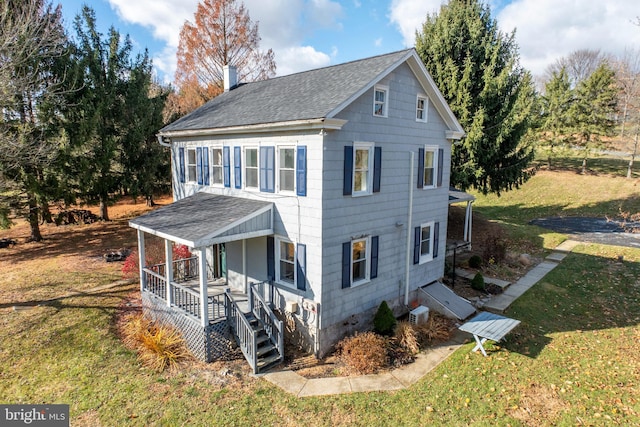 exterior space featuring a porch and a front yard