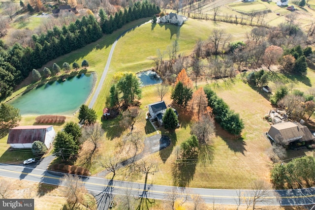 bird's eye view featuring a water view and a rural view