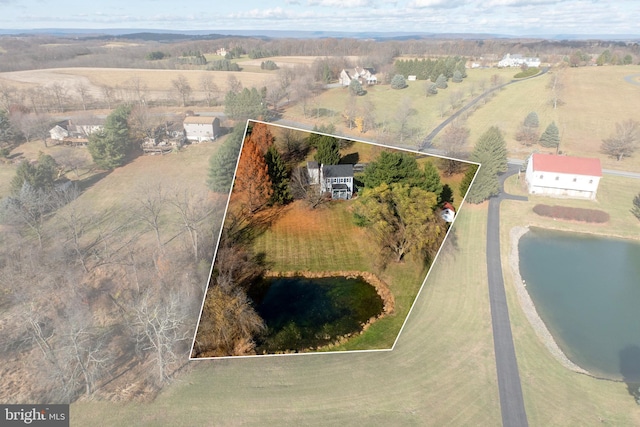 bird's eye view with a water view and a rural view