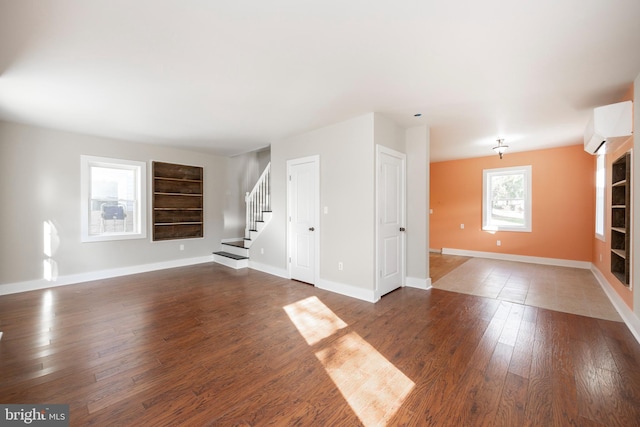 unfurnished living room featuring built in shelves and dark hardwood / wood-style floors