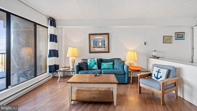 living room with wood-type flooring and baseboard heating