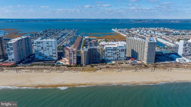 drone / aerial view featuring a view of the beach and a water view